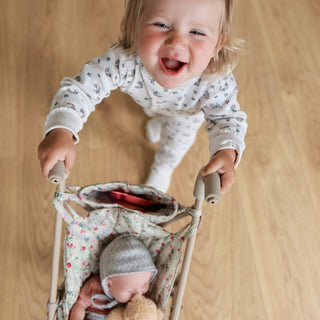 Foldable doll stroller with floral pattern