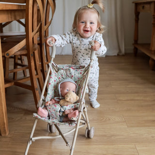 Foldable doll stroller with floral pattern