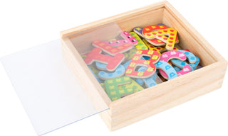 Colorful magnetic letters in a wooden box