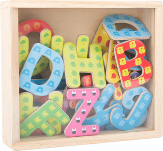Colorful magnetic letters in a wooden box